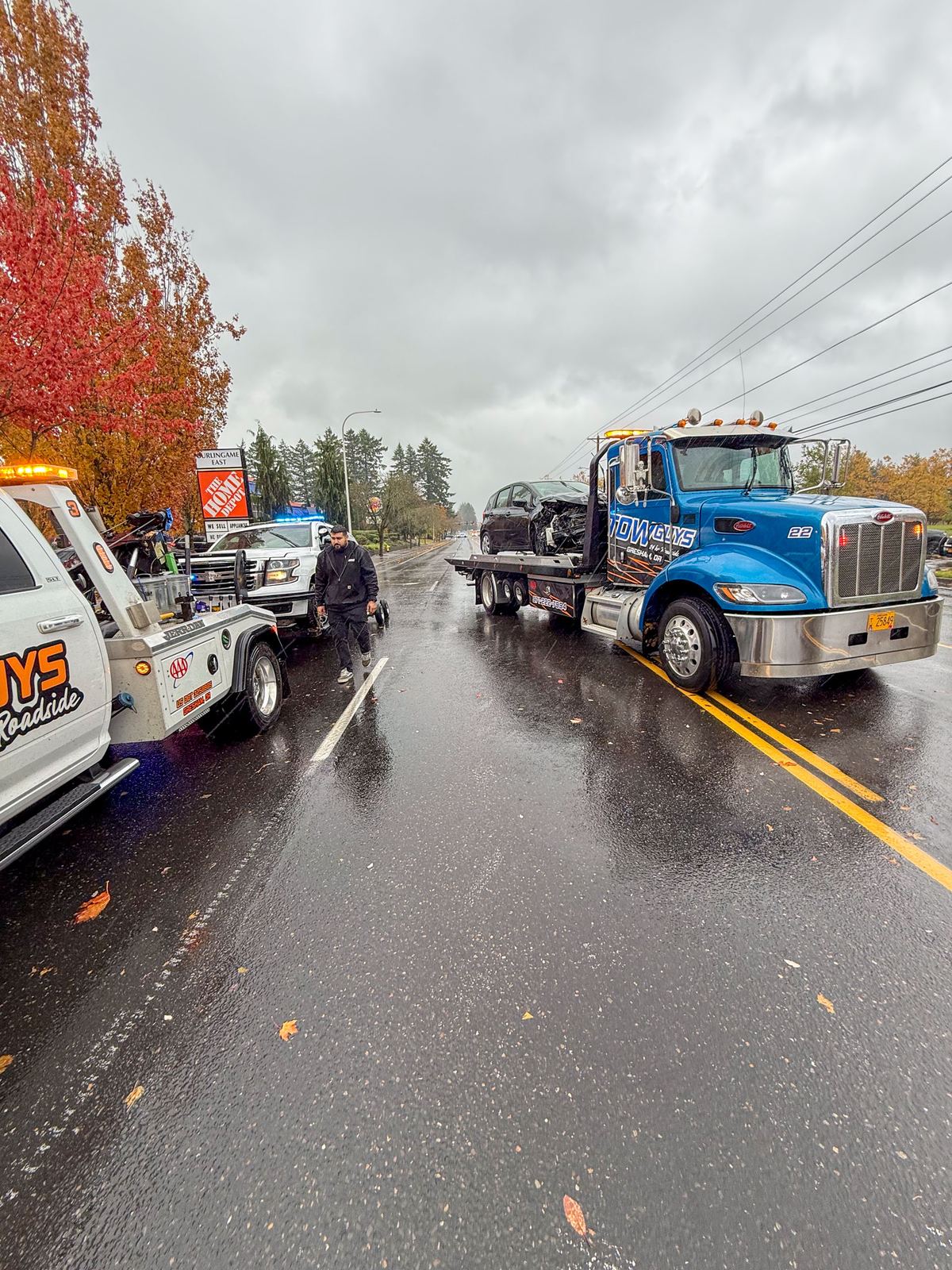 Tow Guys clearing an accident scene on a wet Gresham road