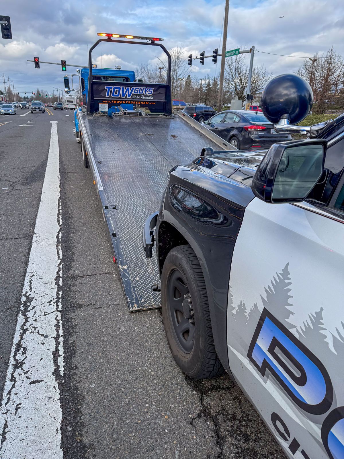 Tow Guys flatbed removing a vehicle in Gresham