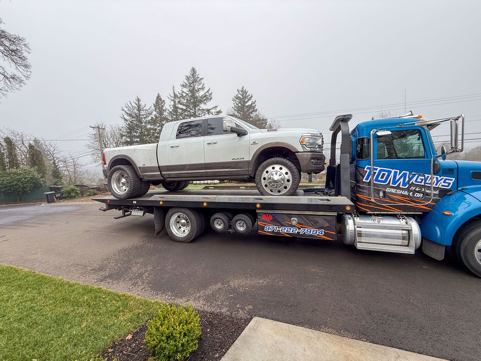 Ram dually pickup loaded on a Tow Guys flatbed tow truck