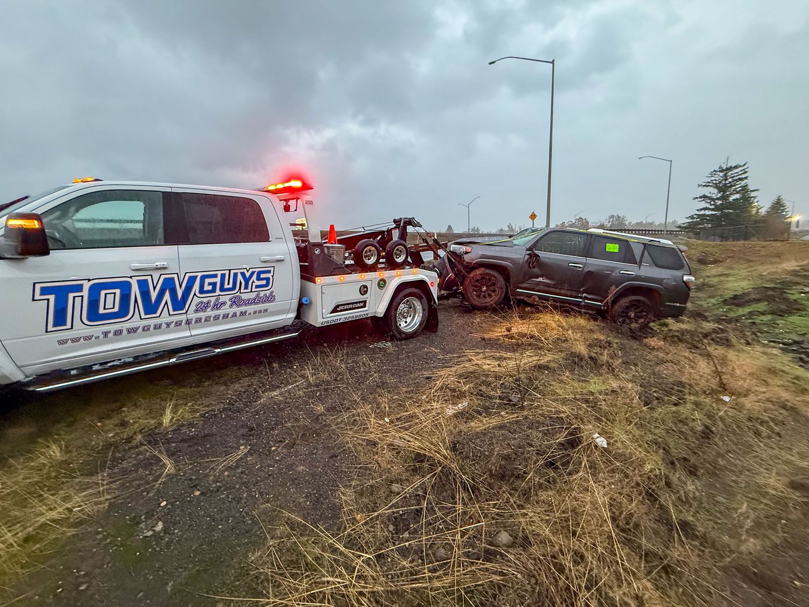 Tow Guys recovering a crashed SUV from an embankment near I-84